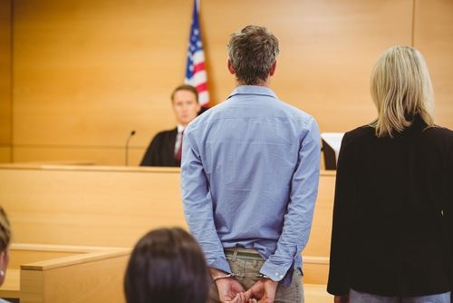 Person wearing handcuffs in court